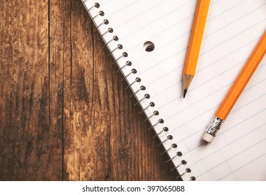 Pencils and a notebook up close