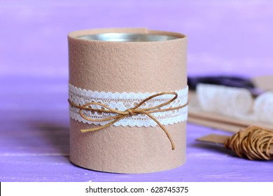 Pencils And Scissors Decorative Holder. Recycled Tin Can For Storage Of Stationery On Wooden Background. Tin Can Decorated With Felt And Lace. Simple And Quick Home Crafts Idea. Closeup