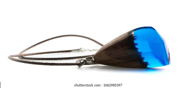 Pendant of Blue Color Isolated on White Background. Bijouterie Made of Epoxy Resin and Wood