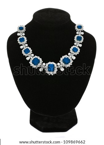 Pendant with blue gem stones on black mannequin isolated on white