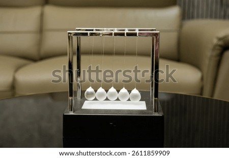 Newton’s Pendulum in Modern Office Space
