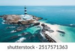 Penghu, Taiwan - July 31, 2024: An aerial view of the Mudouyu Lighthouse,  with a vibrant light blue hue.