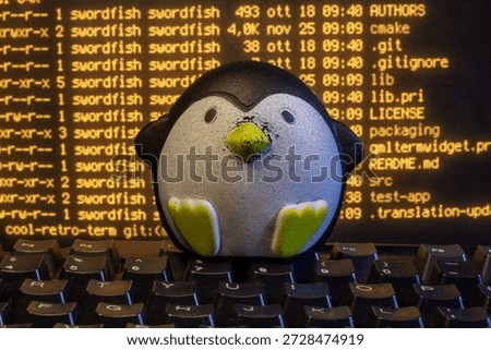 Penguin mascot coding on computer keyboard displaying source code in terminal window