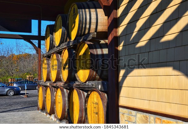 Penn Yan, NY, US- October 31, 2020: Stacked wine\
barrels at the winery, Keuka Spring Vineyards, two-time winner of\
both the Governor\'s Cup for best New York State wine and Best White\
Wine in America.