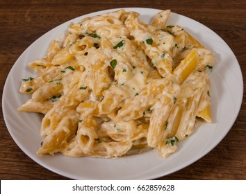 Penne Pasta With Cream Sauce On Wooden Table