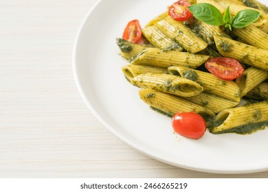 penne pasta with pesto sauce and tomatoes - vegan and vegetarian food style - Powered by Shutterstock