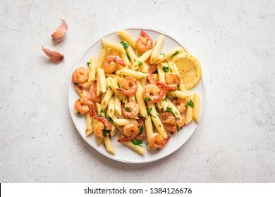 Penne Pasta with Prawns or Shrimps, lemon and garlic on white, top view, copy space. Lemon pasta with sauteed shrimps, fresh seafood. - Powered by Shutterstock