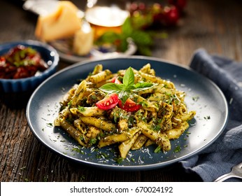 Penne Pasta With Spinach And Chicken, Sprinkled With Parmesan Cheese And Fresh Parsley