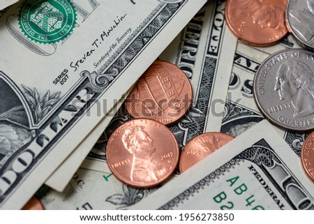 Pennies between dollar bills. US dollar paper money and coins.