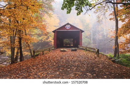 Pennsylvania foggy autumn landscape Josiah Hess red covered bridge spanning Huntington Creek in Orangeville.  The historic bridge is one of the stops on the annual Covered Bridge Festival.