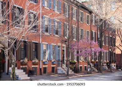 Pennsylvania, PA -March 26 2021: Rows of brownstone apartment buildings in Center City with windows, stoops and planters in Pennsylvania