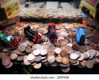 Penny Pusher Or 'Penny Falls' Amusement Machine, With Prizes Of Toy Locomotive Engines