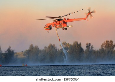 PENRITH, AUSTRALIA - OCTOBER 23, 2013:  NSW Rural Fire Service Erickson Air-Crane Fills With Water To Fight  Bush Fires In The Blue Mountains.  Heavy Smoke Fills The Air.  