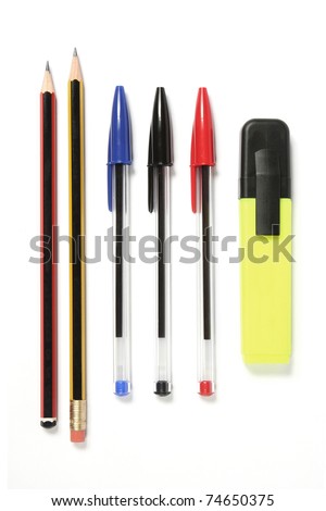 Pens, pencils and a Highlighter. Pens lined up, ready for action. Two pencils, three ball point pens and a hi-lighter pen. These shapes are standard in the UK. Isolated on white.