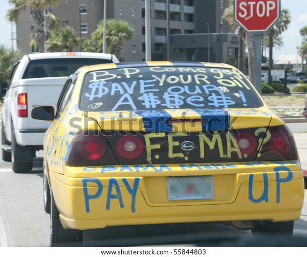 PENSACOLA BEACH - 23 JUNE: A local resident\
advertises their anger about the BP oil spill with writing on a car\
on June 23, 2010 in Pensacola Beach,\
FL.