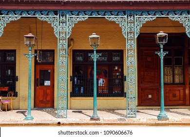 Pensacola, FL, USA September 14,  Three lampposts are framed by intricate Iron Works in  the historic Seville District in Pensacola, Florida