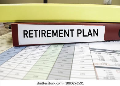 The Pension Plan Is Written On A Red Folder That Lies On Business Documents With Numbers