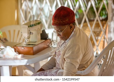 Pensioner African woman with a beanie smiling and being happy - Powered by Shutterstock