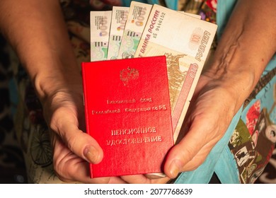 A Pensioner Holds A Pension Certificate And Money In Her Hands. Russia, Ufa. 26.10.2021 