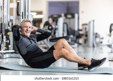 Pensioner Male Staying Fit By Making Situps Inside A Gym.