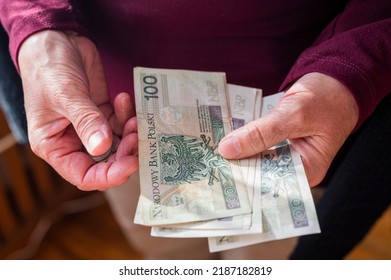 pensioner woman holding in her hands money bills zloty pension and pennies for payment - Shutterstock ID 2187182819