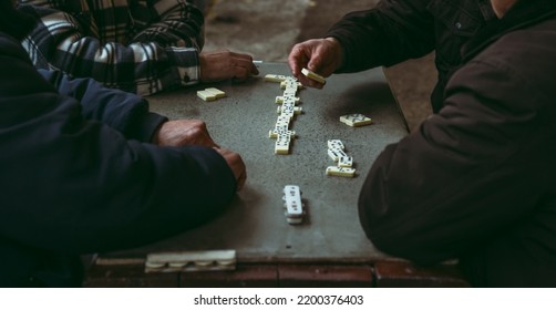 Pensioners, Elderly People Have Fun Playing Dominoes. Men Play Board Games In The Park. The Concept Of Active Recreation.