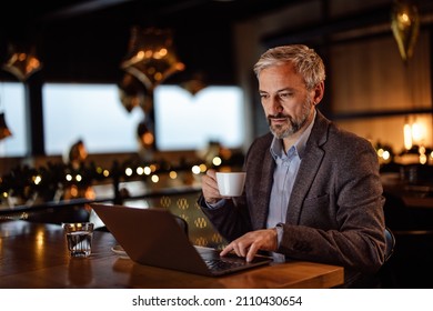 Pensive Adult Man, Coming Up With A Novel In A Restaurant, With A Cup Of Coffee In His Hands.