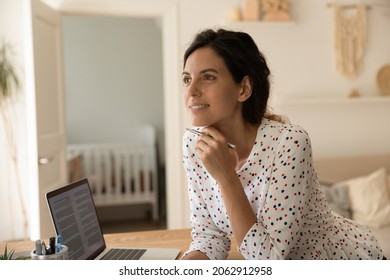 Pensive Adult Student Thinking Over Learning Task, Doing Research At Laptop, Preparing For Exam, Holding Pen, Looking Away, Smiling. Happy New Mom Studying From Home. Distance Education Concept