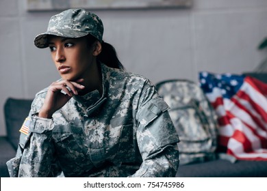 pensive african american female soldier in military uniform 