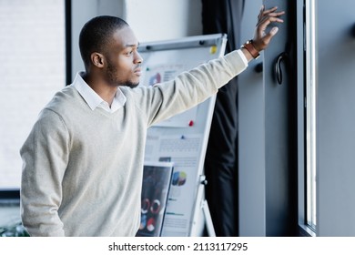 pensive african american man looking at window in office