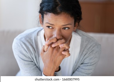 Pensive African American young woman look in distance thinking pondering, thoughtful biracial millennial female lost in thoughts, suffer from depression or miscarriage, psychological help concept