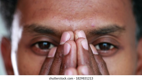 Pensive African Man Covering Face With Hands, Black Person Revealing Eyes Portrait Thinking