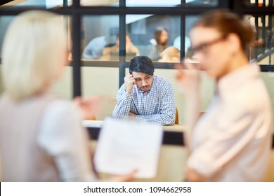 Pensive Applicant Sitting By Table In Boardroom And Worrying Before Interview With Employer