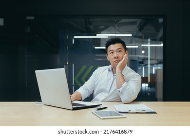 Pensive Asian Businessman Working In Modern Office, Man Thinking About Decision, Experienced Director With Laptop.