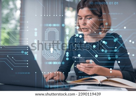 Pensive attractive beautiful businesswoman in formal wear working on laptop talking on pphone in the office. Concept of data protection information technology. lock icon hologram.