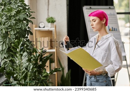 pensive attractive businesswoman in white shirt and jeans holding her phone and looking at her notes