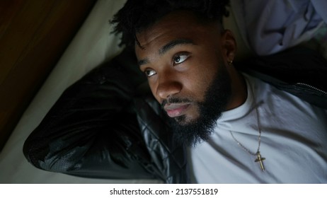 A Pensive Black Man Lying Down In Bed A Resting Young African Man Daydreaming