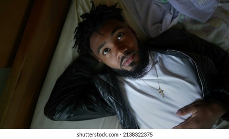 A Pensive Black Man Lying Down In Bed A Resting Young African Man Daydreaming