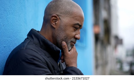 A Pensive Black Senior Man Thinking About Decision Standing Outside In Street