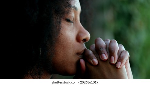 Pensive black woman praying. Thoughtful African person seeking help