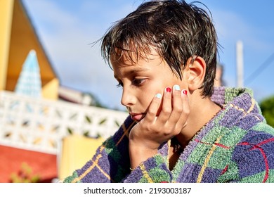 Pensive Boy In Bathrobe With Painted Nails