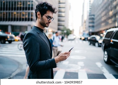 Pensive Businessman In Suit Read Incoming Notification With Money Balance On Account Received On Smartphone Crossing New York Street.Prosperous Entrepreneur In Formal Wear Checking Mail On Telephone