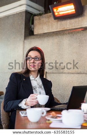 Similar – Young woman stiring coffee looking back