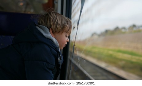 Pensive Child Daydreaming Inside Train Looking Out Wagon Window