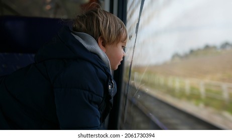 Pensive Child Daydreaming Inside Train Looking Out Wagon Window