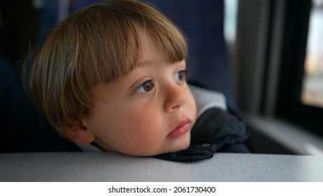 Pensive Child Daydreaming Inside Train Looking Out Wagon Window