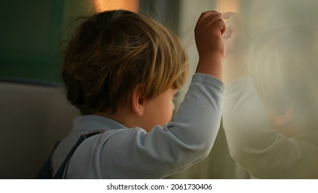 Pensive Child Daydreaming Inside Train Looking Out Wagon Window