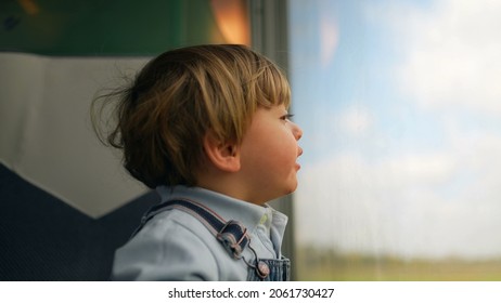 Pensive Child Daydreaming Inside Train Looking Out Wagon Window