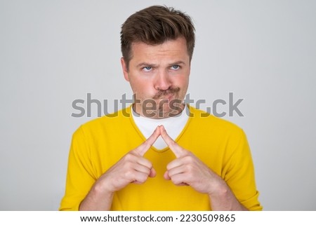 Pensive curious man in thinking pose trying to make choice or decision 
