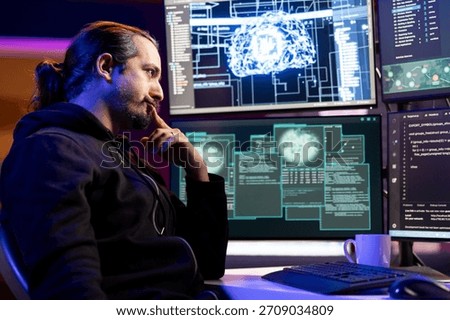 Pensive cybercriminal coding on PC, brainstorming ways to evade security with stealth malware. Evil man thinking how to use exploit hiding malicious code from detection systems